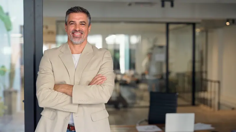 Confident man poses in a modern office