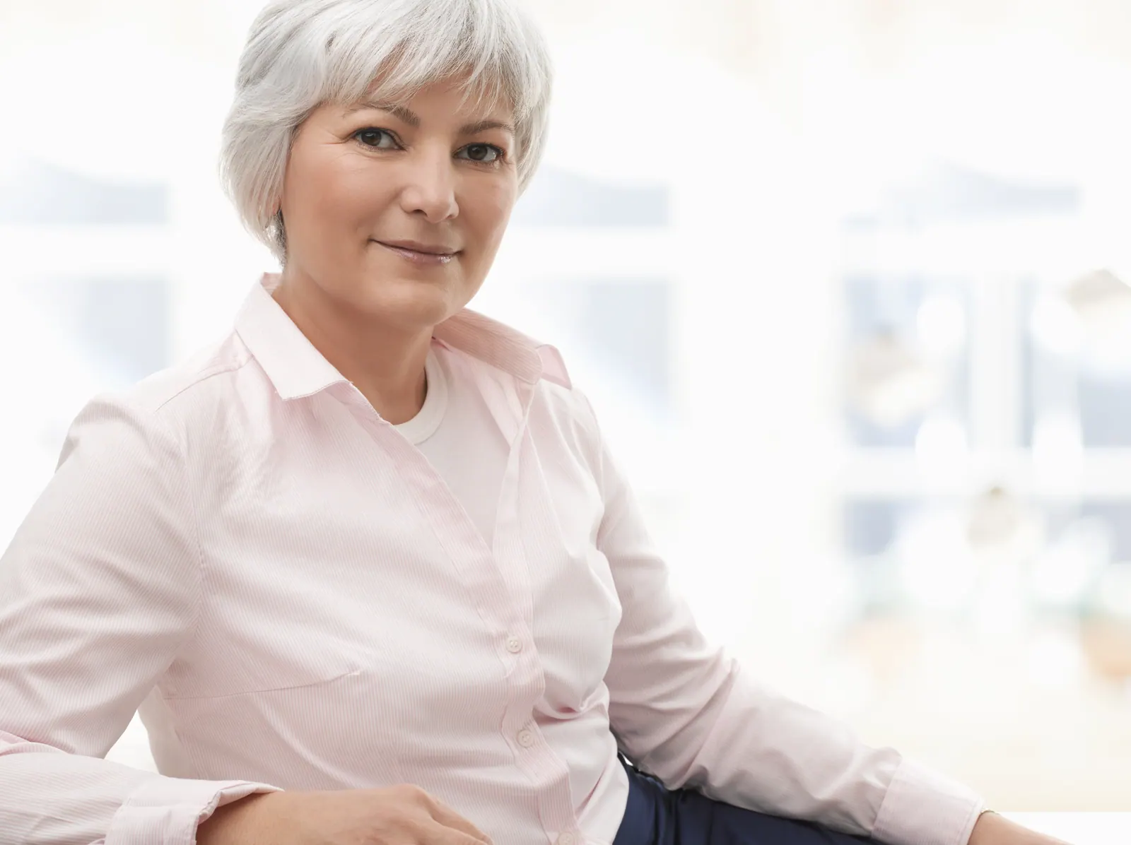 Confident woman poses in natural light indoors