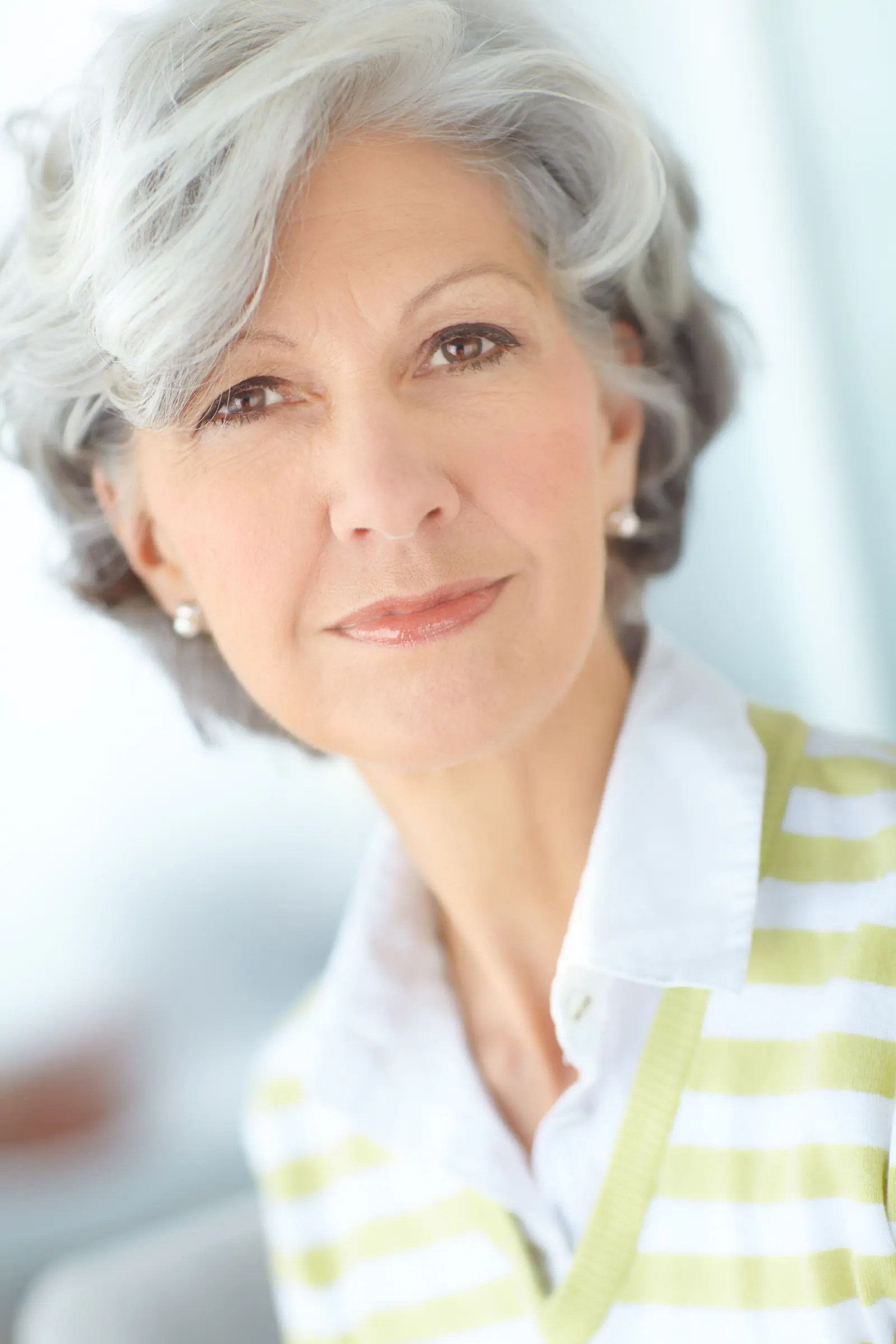 Senior woman smiling and posing indoors
