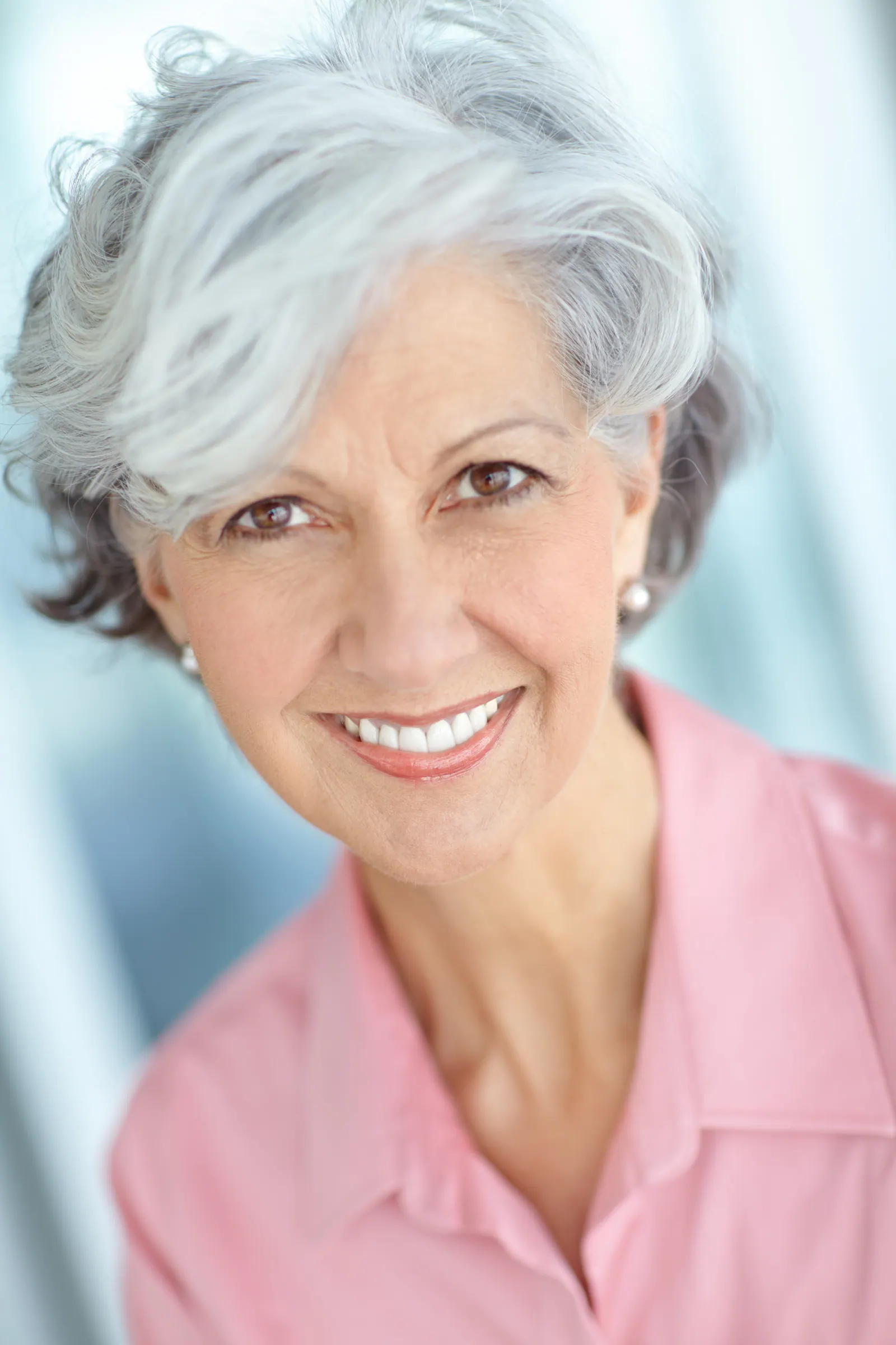 Smiling senior woman in pink shirt
