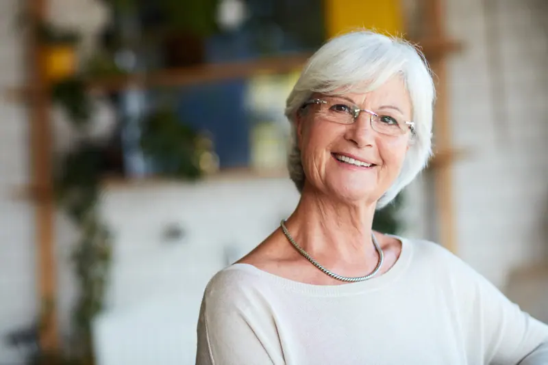 Smiling senior woman portrait in a bright home