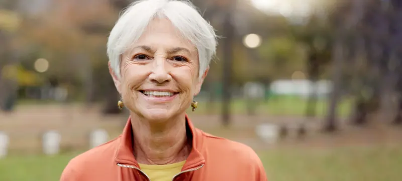 Smiling senior woman portrait outdoors in natural