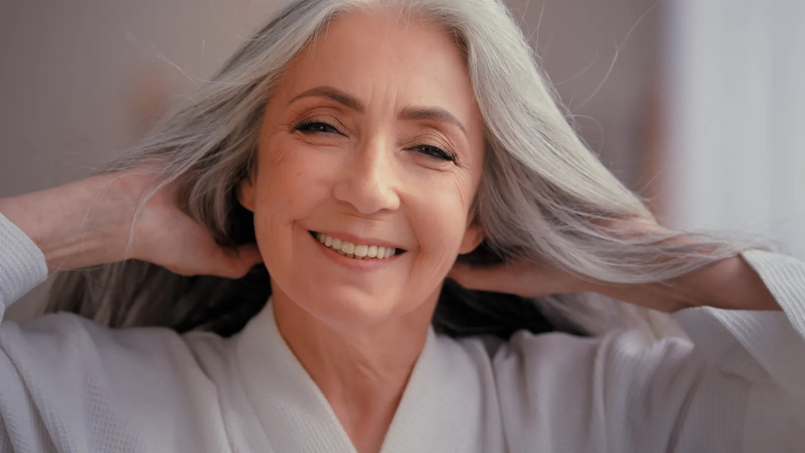 Smiling senior woman posing in comfortable robe