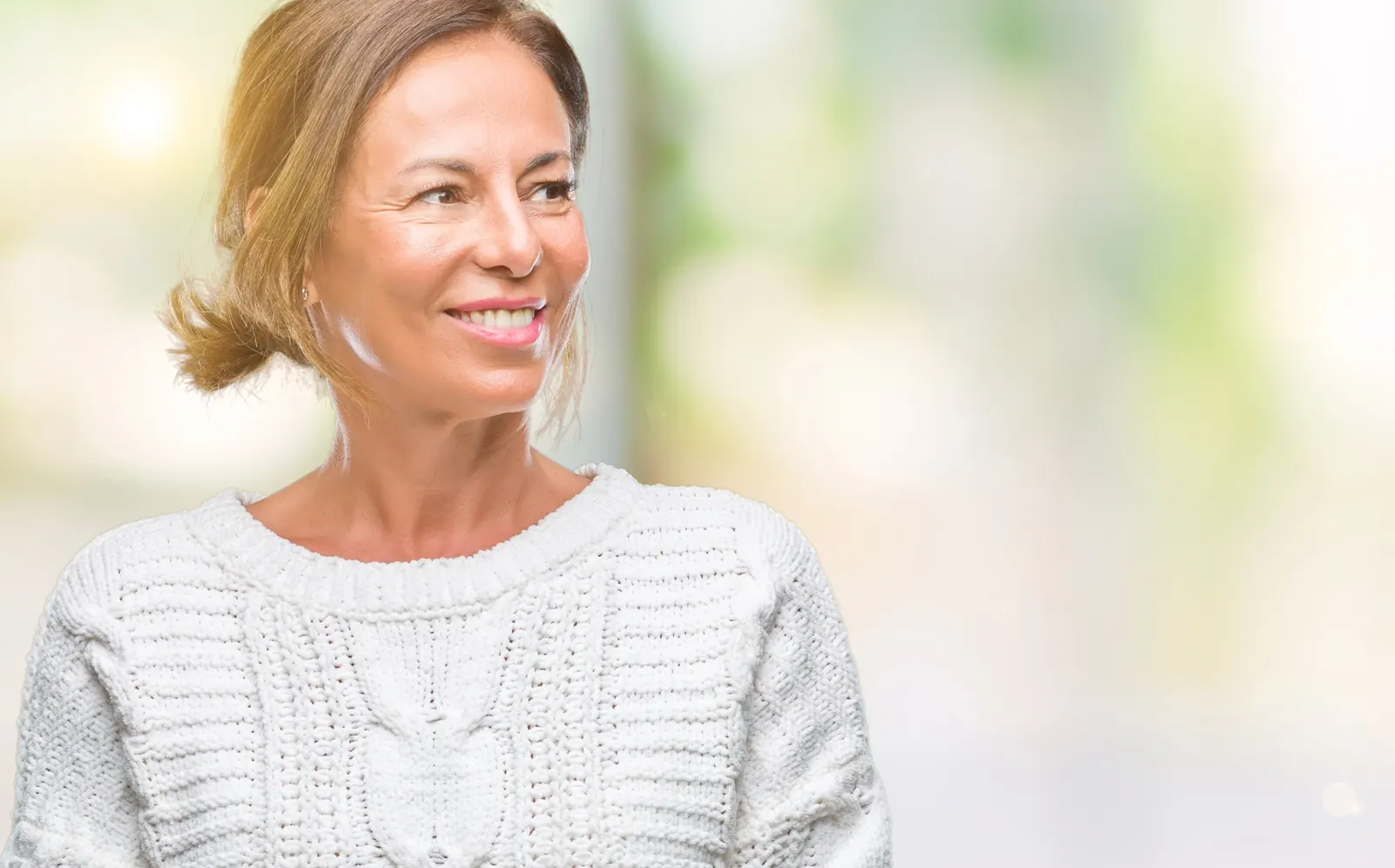 Smiling woman in sweater looking away from camera