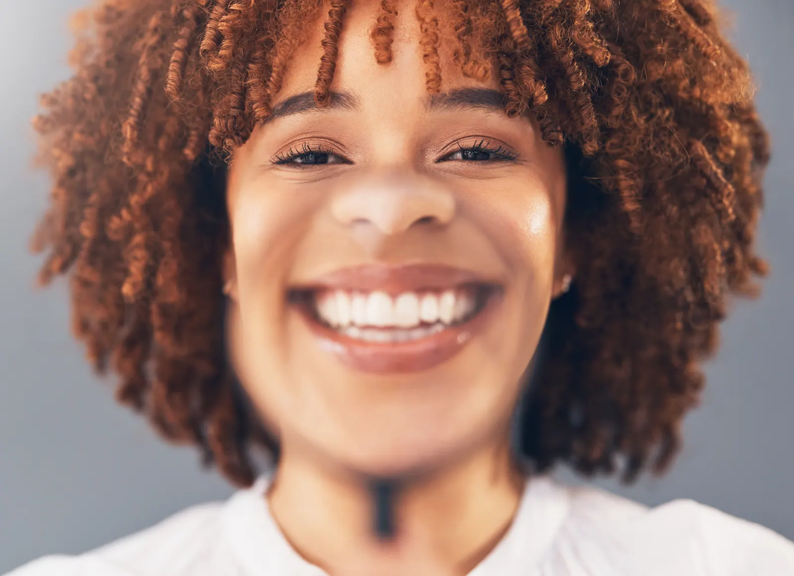 Smiling woman portrait with curly hair close up