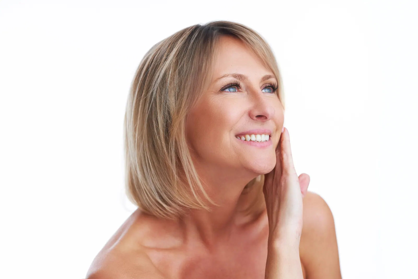 Smiling woman posing with hand on face
