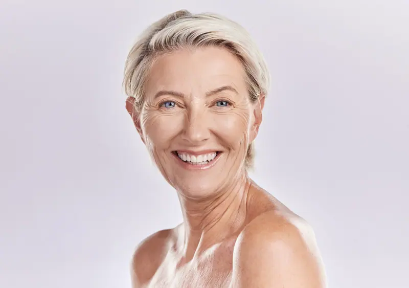 Smiling woman shows radiant skin in headshot