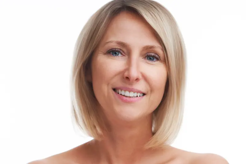 Smiling woman with blonde bob hairstyle posing