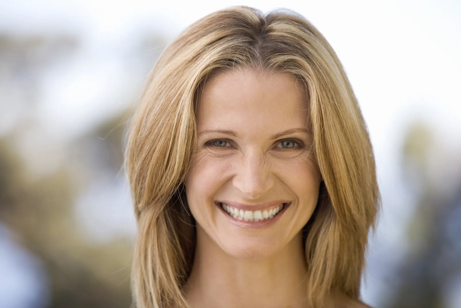 Smiling woman with long blonde hair portrait