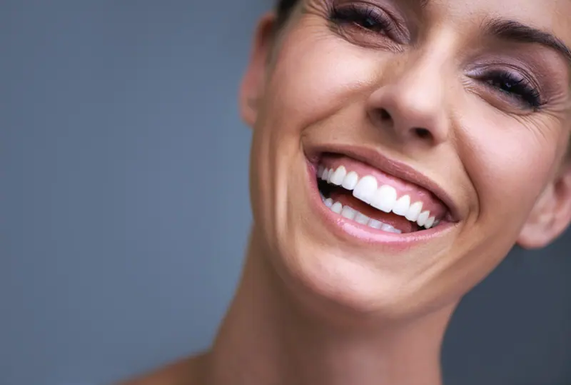 Smiling woman with perfect white teeth close up
