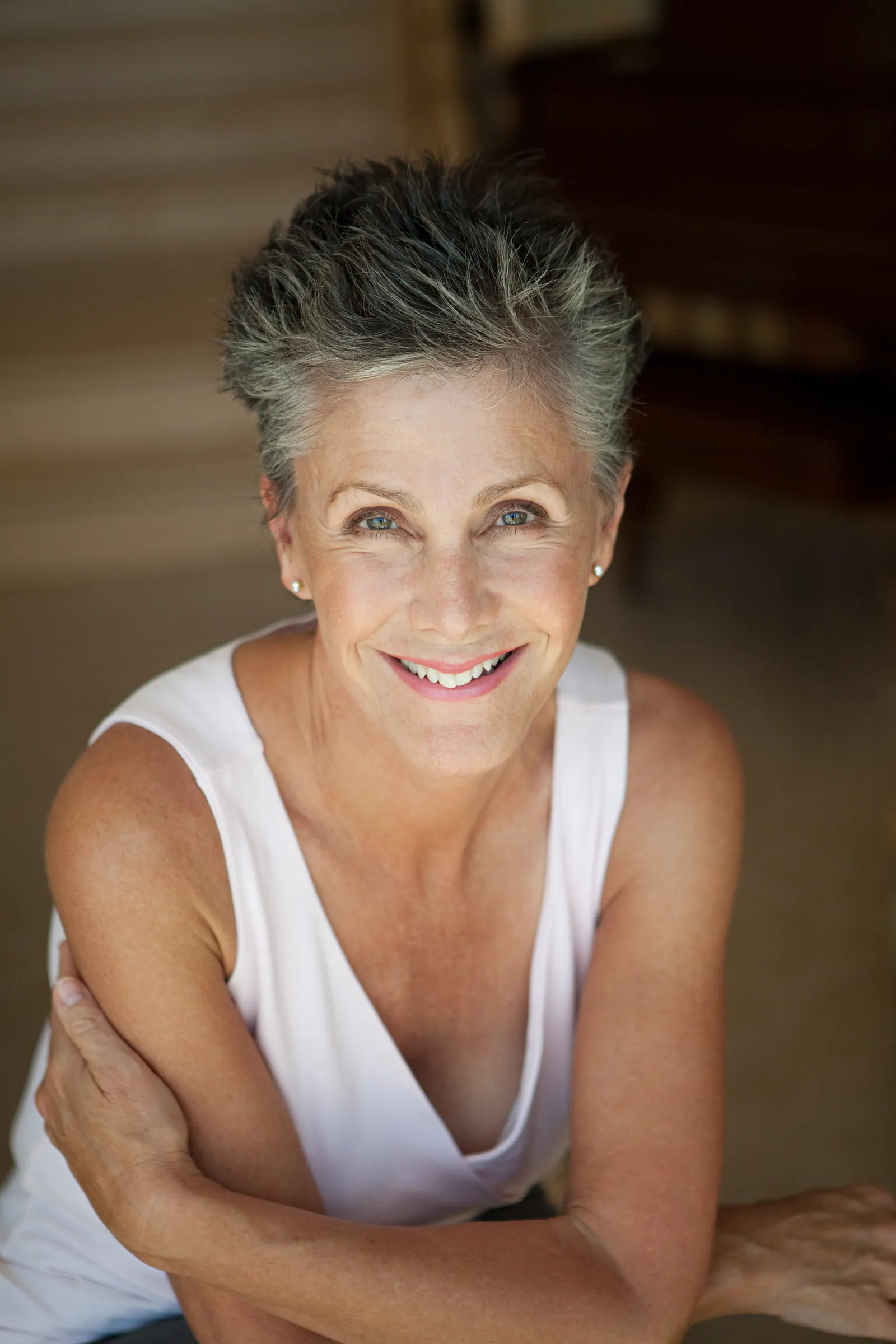 Smiling woman with short gray hair and tank