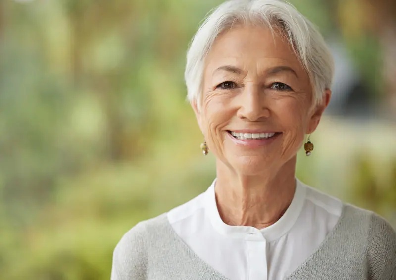 Smiling woman with short gray hair posing